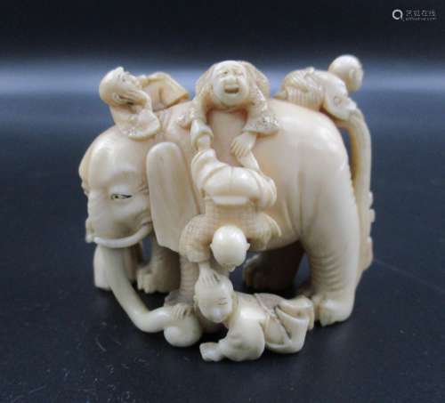 A Japanese Meiji period ivory netsuke, modelled as six blind men and an elephant, as an allegory