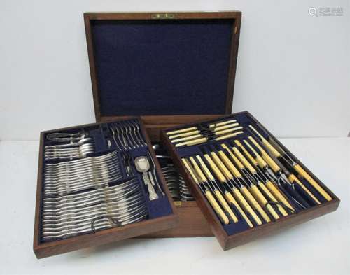 A triple tray cased canteen of silver cutlery, with twelve place settings, of various silver dates