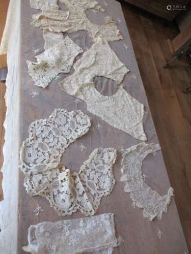 A Victorian cream lace machine made rectangular tablecloth having a hand sewn border of flora and