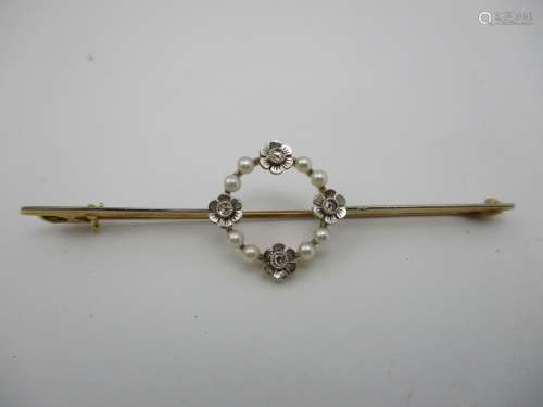 A gold bar brooch set with a band of seed pearls and diamonds in flowers design setting, stamped