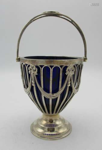 An Edward VII silver swing handle sugar bowl by Goldsmiths and Silversmith co., with pierced body