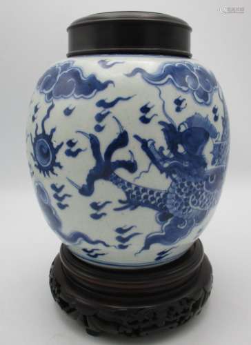 A Chinese Kangxi blue and white porcelain ginger jar, with dragon and pearl design, turned wooden