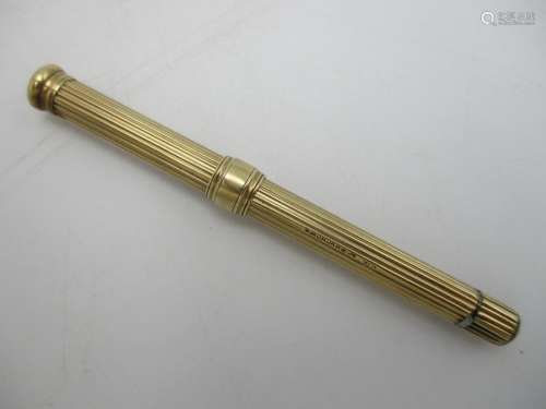 A 9ct gold Sampson Mordan retracting pencil, with central sliding ring, 9 cm long (shut)