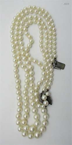 A two row strand cultured pearl necklace, 84 and 77 graded pearls hanging on a silver clasp