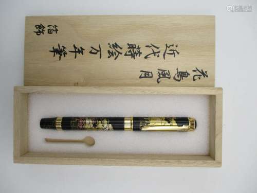 A Japanese Maki-e fountain pen, elaborately decorated with a lacquer design of Autumnal landscape