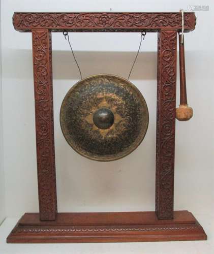 An early 20th century South East Asian nipple gong, of circular form with hammered metal and