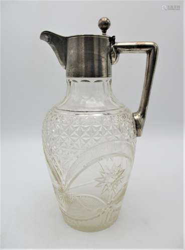 A late 19th century German silver mounted claret jug, the cut glass body of ovoid shape with