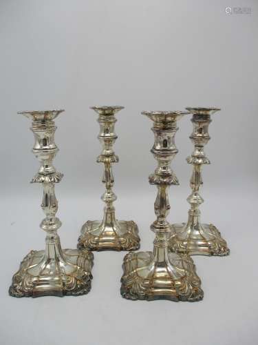 A set of four Georgian style silver plated candlesticks, with detachable sconces, the capitals and
