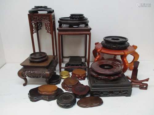 A collection of Chinese hardwood stands and bases, of various shapes and sizes.