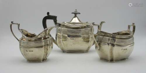 A late Victorian silver three piece tea set by John Round & Son, Sheffield 1895, retailed by Edwards