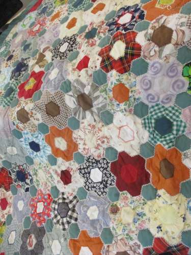 A late 20th century handmade quilt, multicoloured cotton flower design with a green border, 72