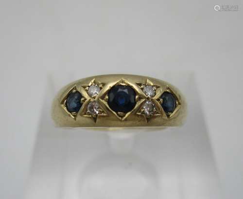 A 9ct gold ring set with three sapphires and four diamonds, 3.2g, size N