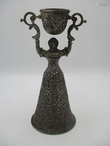 A large Continental silver plated wager cup, cast as a lady holding aloft a swivelling cup,