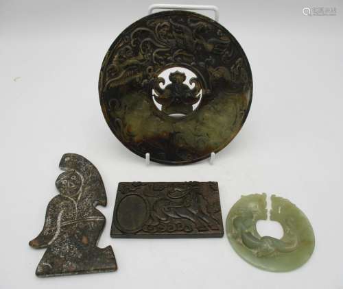 A group of four Chinese jade carvings, to include a large circular disc carved with various mythical