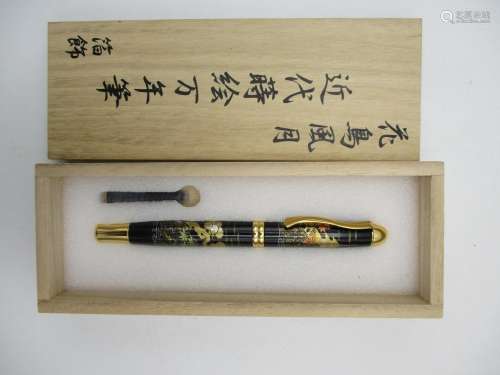 A Japanese Maki-e fountain pen, elaborately decorated with a lacquer design of an Autumnal landscape
