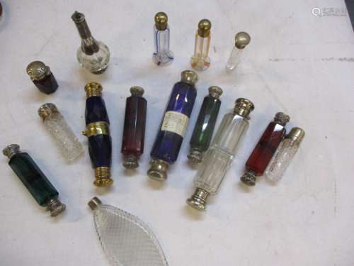 A quantity of Victorian and later scent bottles to include double ended and silver topped bottles,