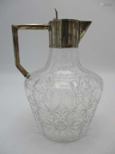 A Victorian silver mounted claret jug, with star cut glass baluster shaped body, the silver mounts