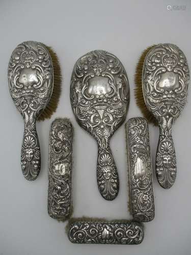 A group of English silver mounted dressing table brushes, all mostly dated between 1897 and 1901,