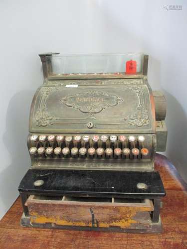 A National Cash Register Co brass till with floral spandrel panels, the hinged front enclosing dials