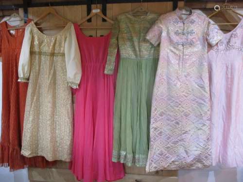 A collection of six 1970s ladies evening gowns to include a dark pink chiffon, long sleeved and full