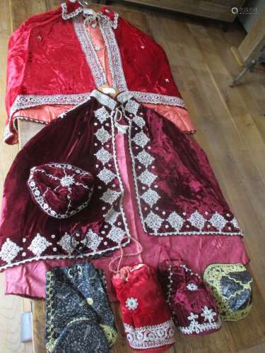 Two late 19th century Middle Eastern embroidered velvet shoulder capes, in two tones of red,