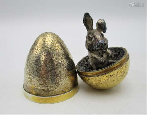 A Stuart Devlin novelty silver gilt surprise egg, London 1992, the inside revealing a model of a