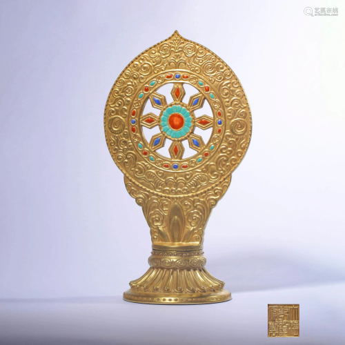 A Golden Dharmachakra Ornament