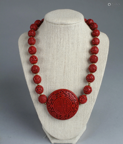 A Cinnabar Lacquer Pendant with Necklace