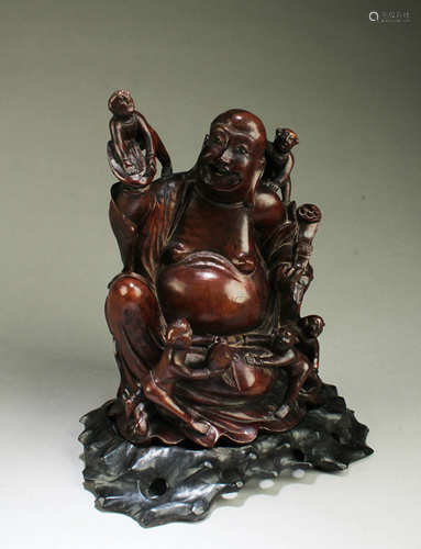 A Carved Wooden Smiling Buddha Statue