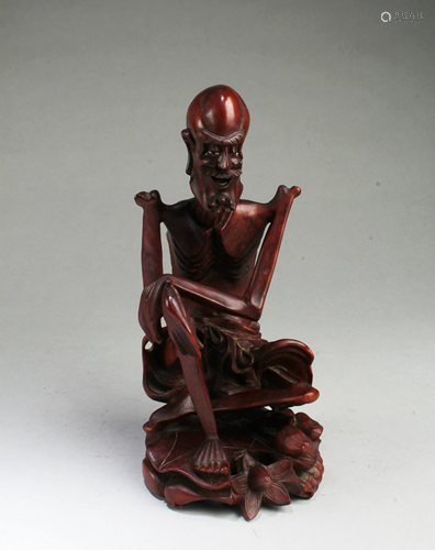 A Carved Wooden Monk Figurine