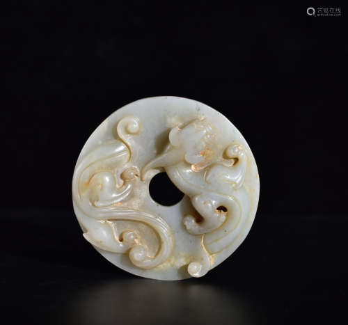 A WHITE JADE PLATE WITH DRAGON PATTERN