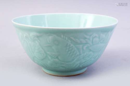 A CHINESE CELADON MOULDED PORCELAIN CARP BOWL, the bowl with carved decoration of fish and lotus,