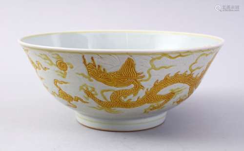 A CHINESE YELLOW INCISED PORCELAIN DRAGON BOWL, the base with a six character mark to base, 19cm.