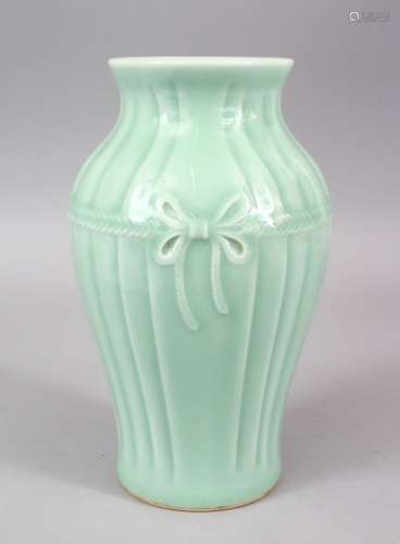 A GOOD CHINESE CELADON CARVED BOW PORCELAIN VASE, the base with a six character mark, 23cm high .
