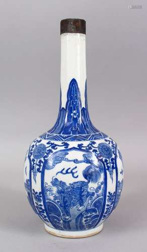 A GOOD CHINESE BLUE & WHITE PORCELAIN BOTTLE VASE, with panels of native flora and lion dogs, around