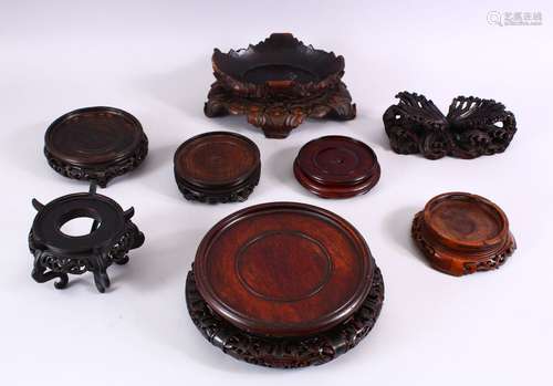 A MIXED LOT OF EIGHT LARGE CHINESE CARVED HARDWOOD STANDS, various styles and sizes. 18cm down to