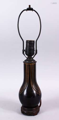 AN AFRICAN CARVED WOODEN LAMP VASE, the inner shaking like a maraca, 40cm high.