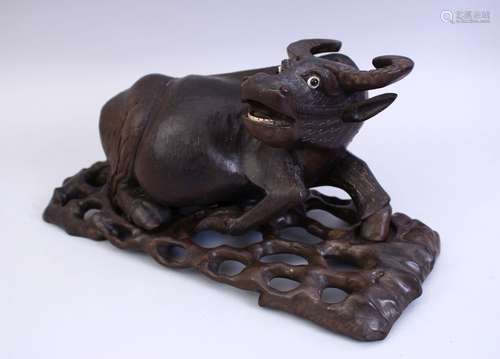 A GOOD 19TH CENTURY CHINESE CARVED HARDWOOD AND INLAID SILVER WATER BUFFALO, the buffalo recumbent