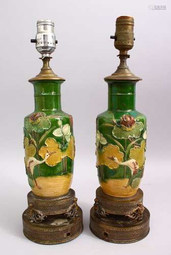 A PAIR OF CHINESE SANCAI STYLE PORCELAIN LOTUS VASES / LAMPS, with moulded lotus decoration with