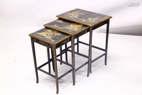 A 19TH CENTURY CHINESE LACQUER DECORATED NEST OF TABLES, decorated with views of landscapes and