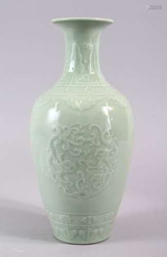 A CHINESE CELADON PORCELAIN CARVED VASE, decorated with borders of Ruyi with roundel of chiilong,