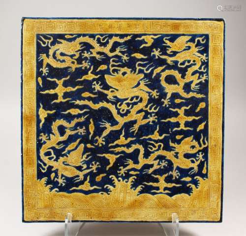 AN UNUSUAL LARGE CHINESE MING STYLE YELLOW & BLUE PORCELAIN TILE, with incised decoration of dragons