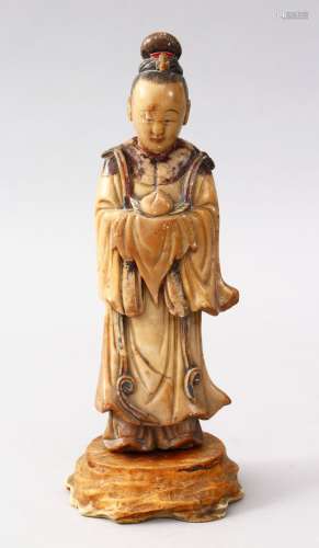 A GOOD 18TH CENTURY CHINESE CARVED & PAINTED SOAPSTONE FIGURE, possibly of guanyin, holding a fruit,