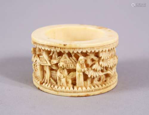 A CHINESE CANTON CARVED IVORY NAPKIN RING, carved with figures in landscapes, 5cm.