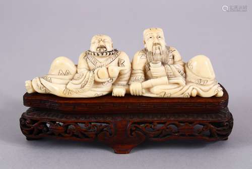 AN EARLY 20TH CENTURY CHINESE CARVED IVORY FIGURE OF TWO DRINKING MEN, both men seated drinking from