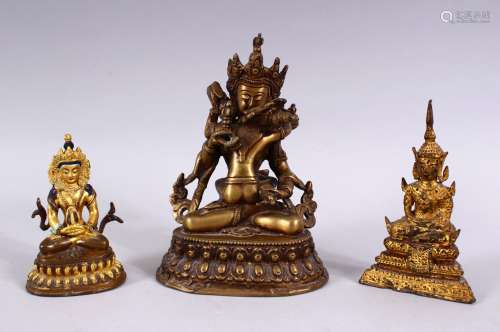 THREE TIBETAN GILT BRONZE FIGURES, each with varying pose, the smallest with poly chrome decoration,