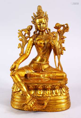 A CHINESE GILT BRONZE FIGURE OF BUDDHA, in a seated position with one hand aloft, seated on a