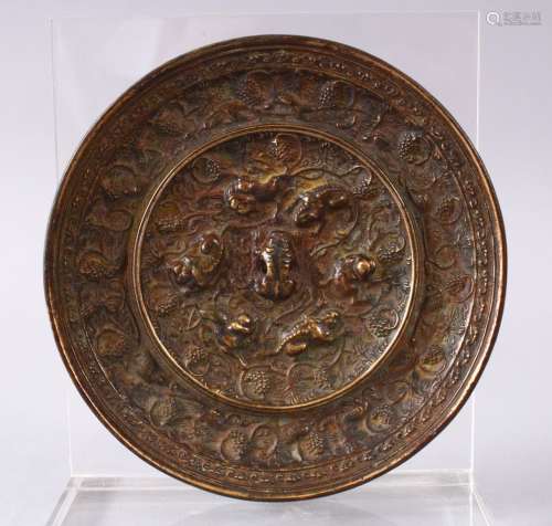 A GOOD 19TH CENTURY OR EARLIER CHINESE BRONZE TANG STYLE MIRROR, with vine decoration and moulded