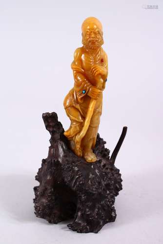 A CHINESE CARVED NATURAL SOAPSTONE FIGURE OF LUOHAN ON STAND, the figure well carved depicting