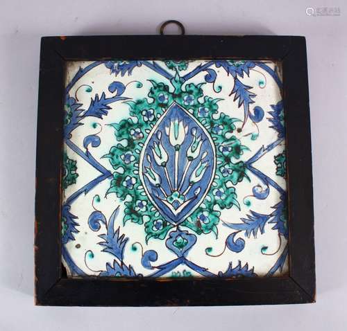 A GOOD EARLY FRAMED IZNIK TILE , decorated with floral motif decoration, 28cm x 27.5cm